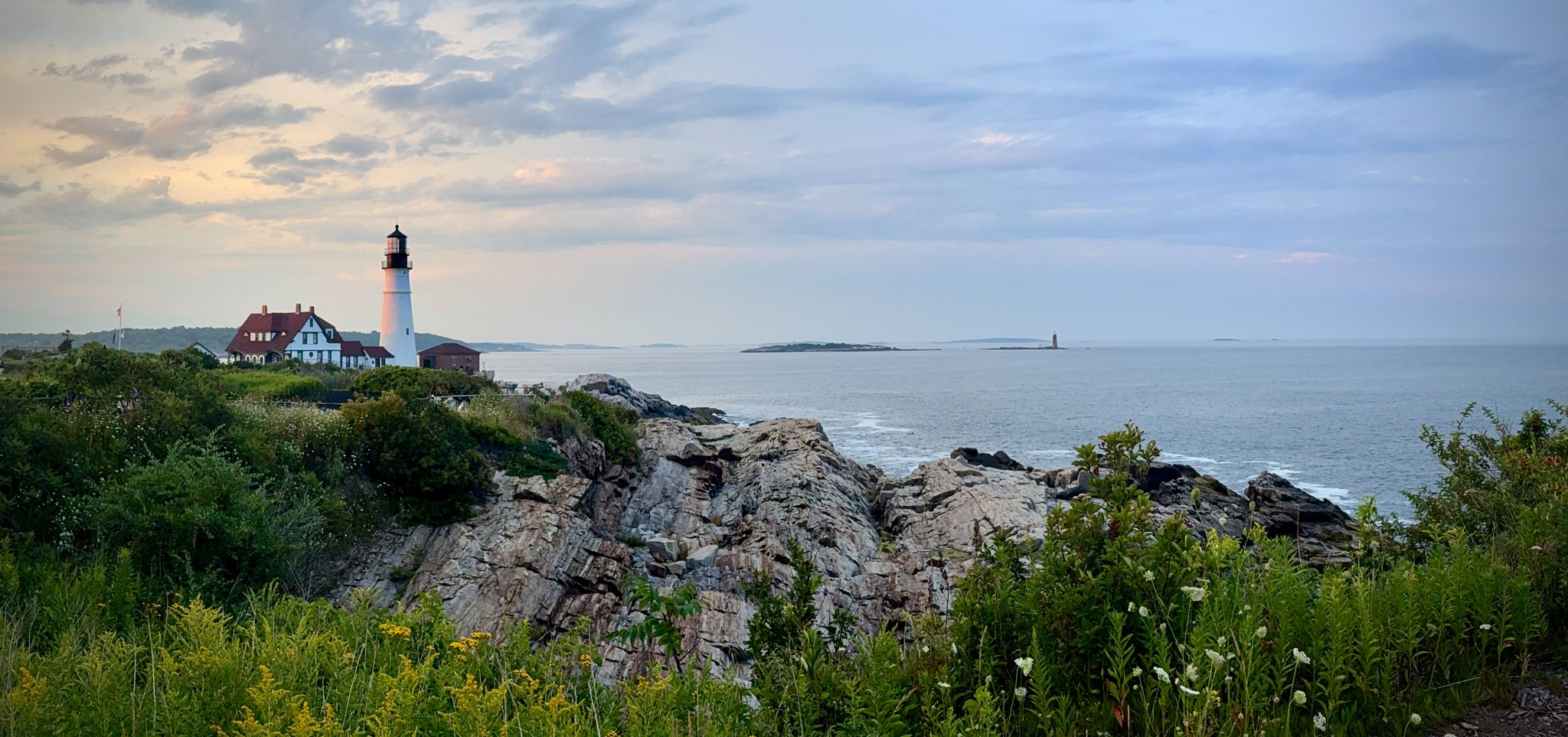 Portland Head Light at dusk, wide across the cove